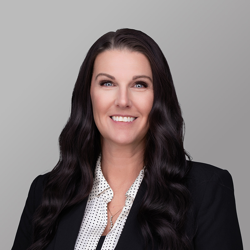 Alicia Worthy is dressed professionally. Her hair is dark and wavvy, and she's smiling at the camera.